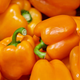 Pile of bright orange bell peppers